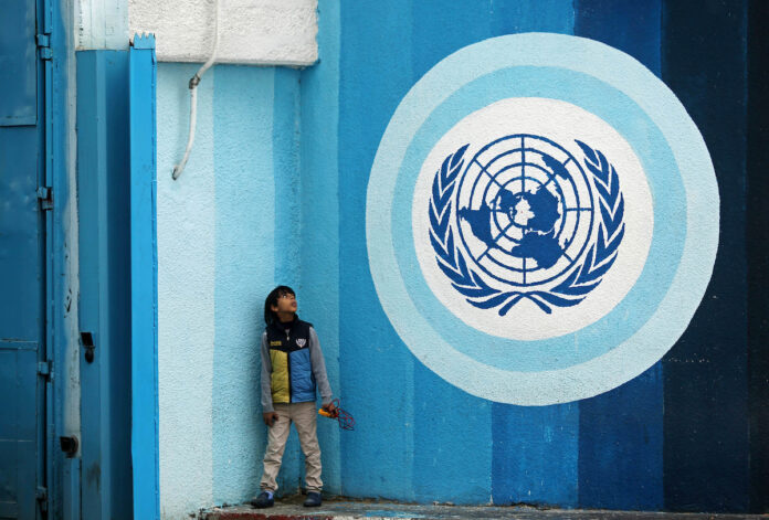 A Palestinians boy sits near the headquarters United Nations Relief and Works Agency (UNRWA) in Gaza city